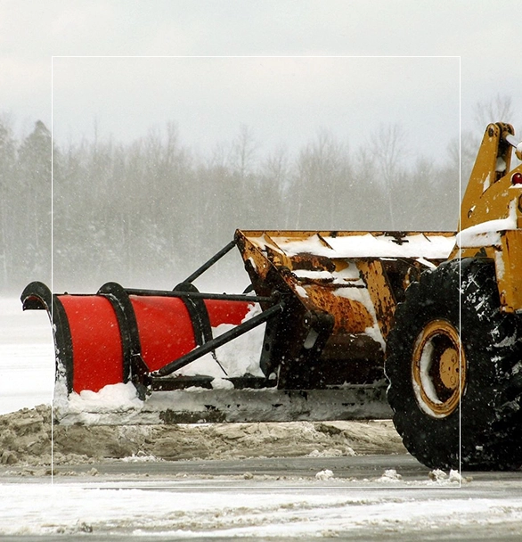 A snow plow is being used to clear the road.